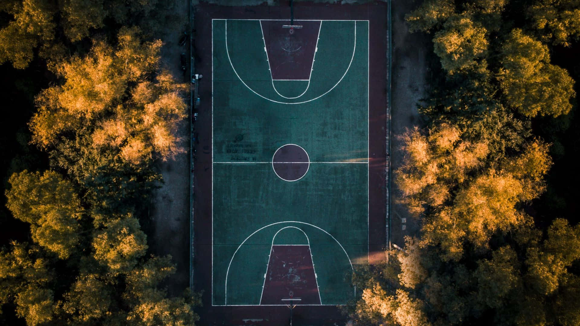 Aerial View Of A Basketball Court In The Park
