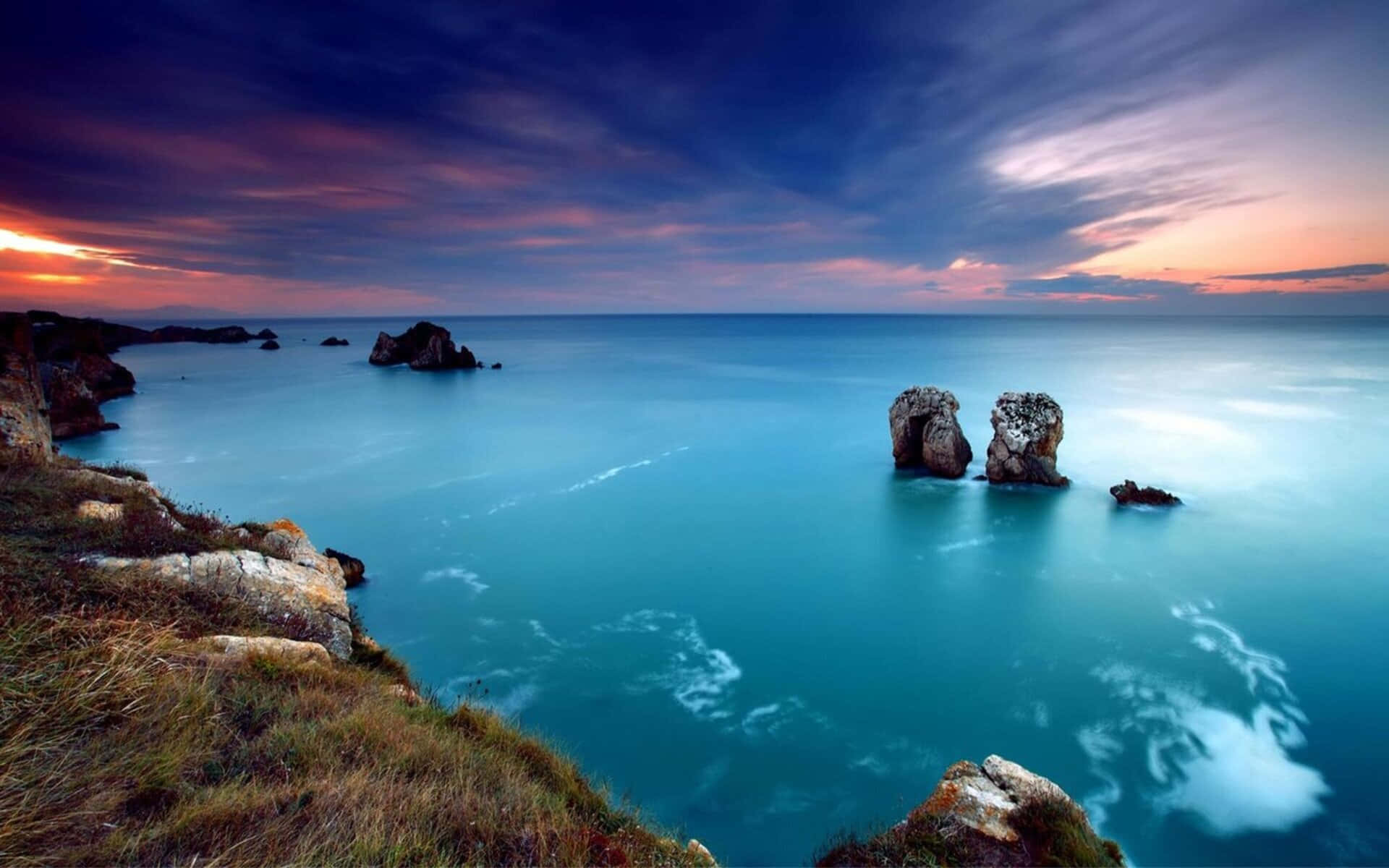 Fondode Pantalla De Naturaleza En Alta Definición (1080p) Con Un Mar Rocoso Azul.