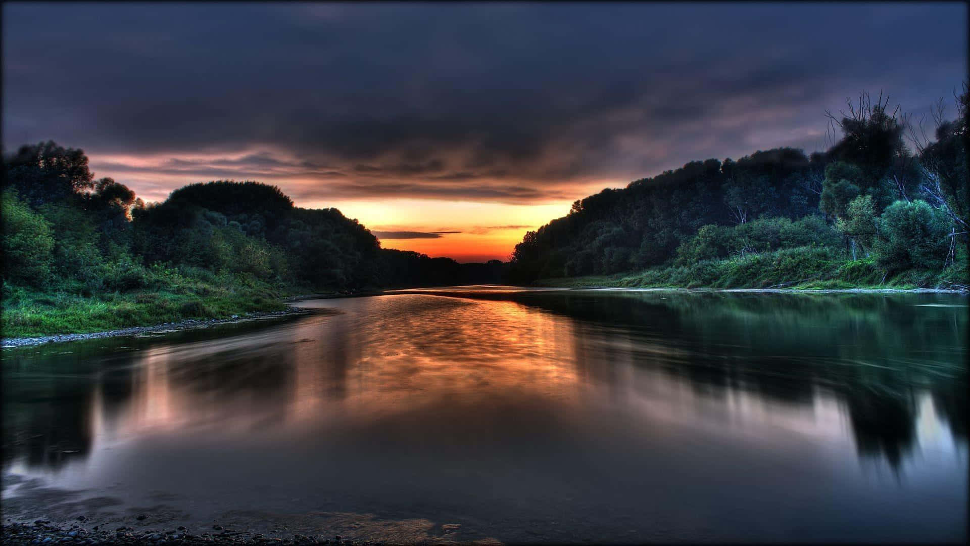 A River With Clouds And Trees At Sunset