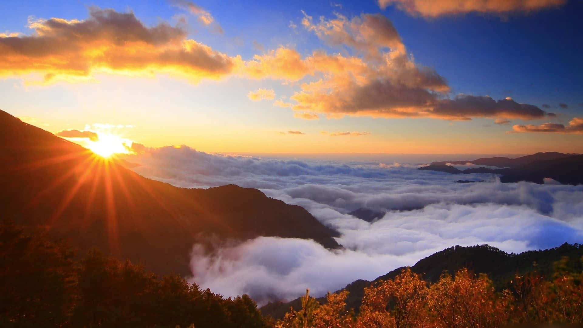 A Sunrise Over Clouds In The Mountains