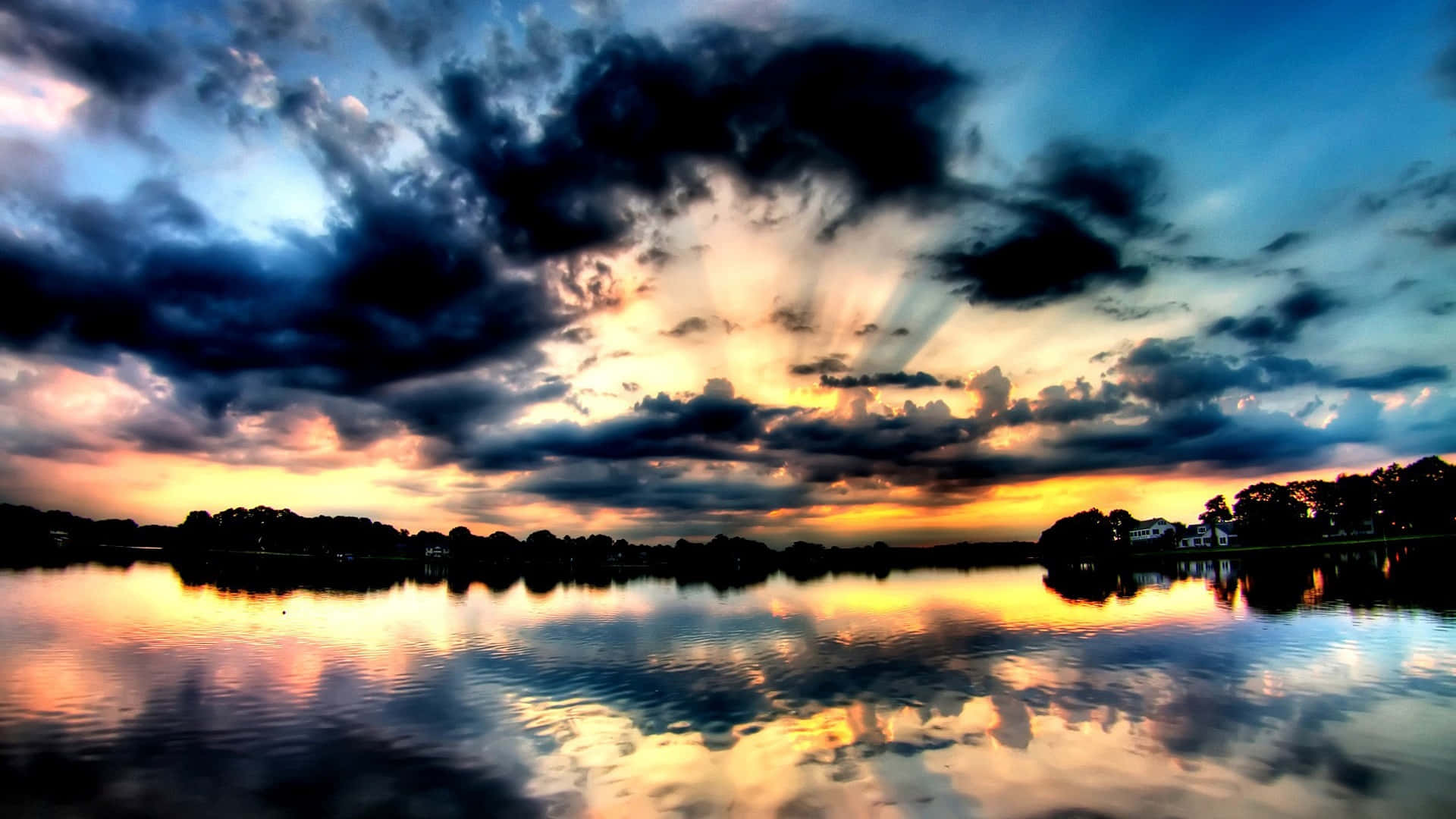 A Beautiful Sunset Over A Lake With Clouds