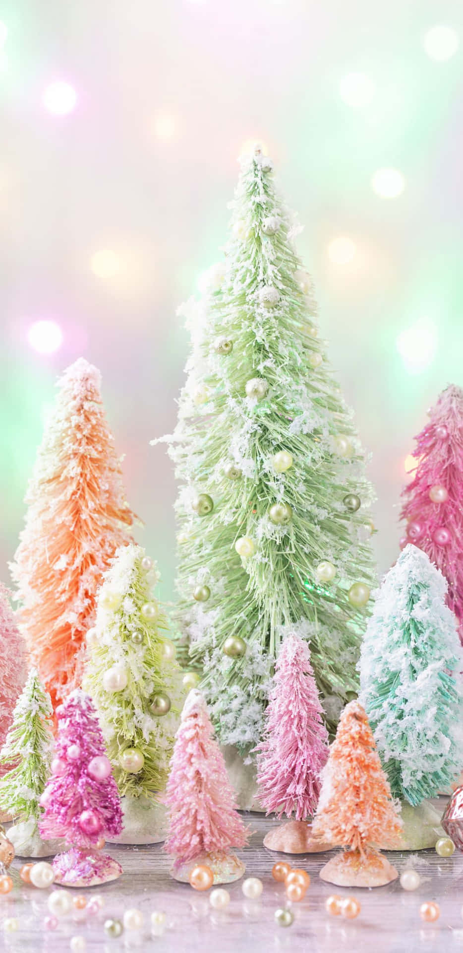 A Group Of Small Christmas Trees With Colored Frosting Wallpaper