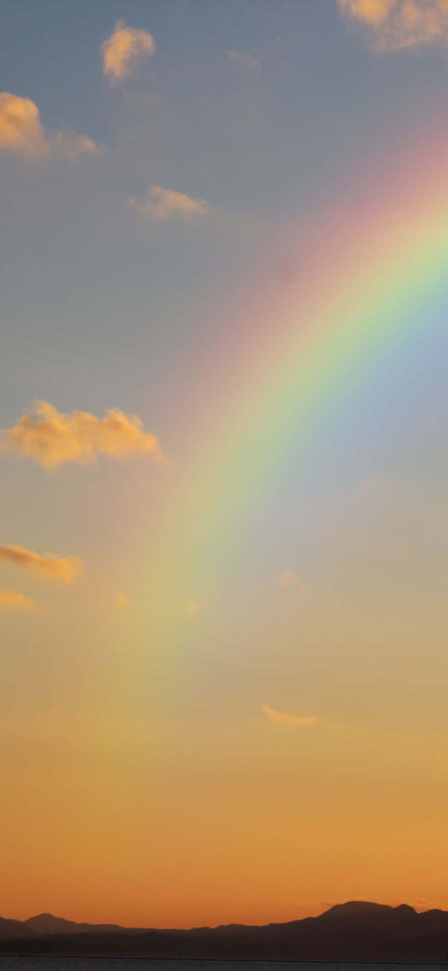 a rainbow is seen over a body of water Wallpaper