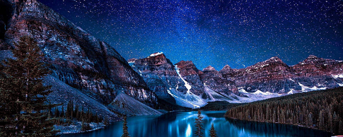 1200x480Starry Sky Over Snowy Mountains Wallpaper
