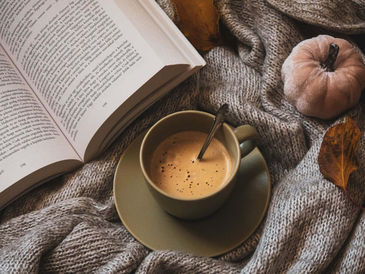 A Cup Of Coffee And An Open Book On A Blanket Wallpaper