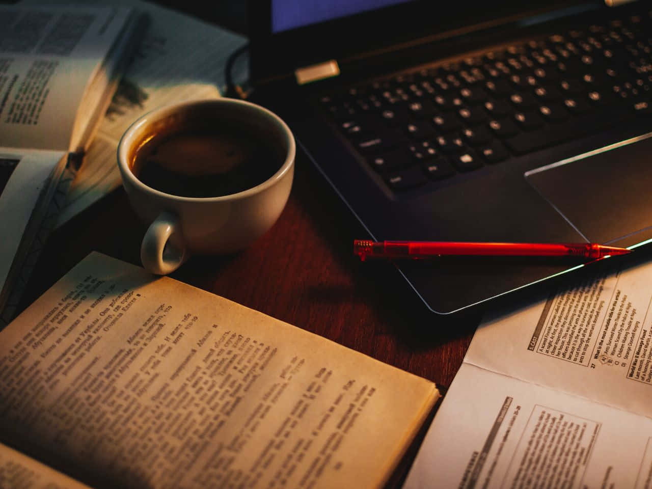 A Laptop, Books, And A Cup Of Coffee On A Table Wallpaper