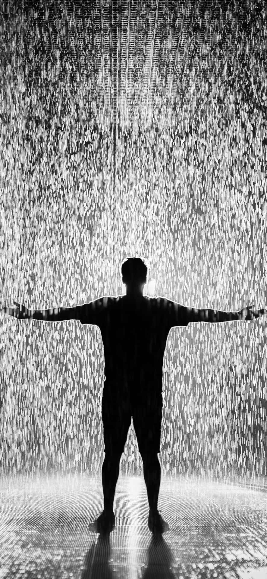 A Person Standing In A Water Fountain Wallpaper