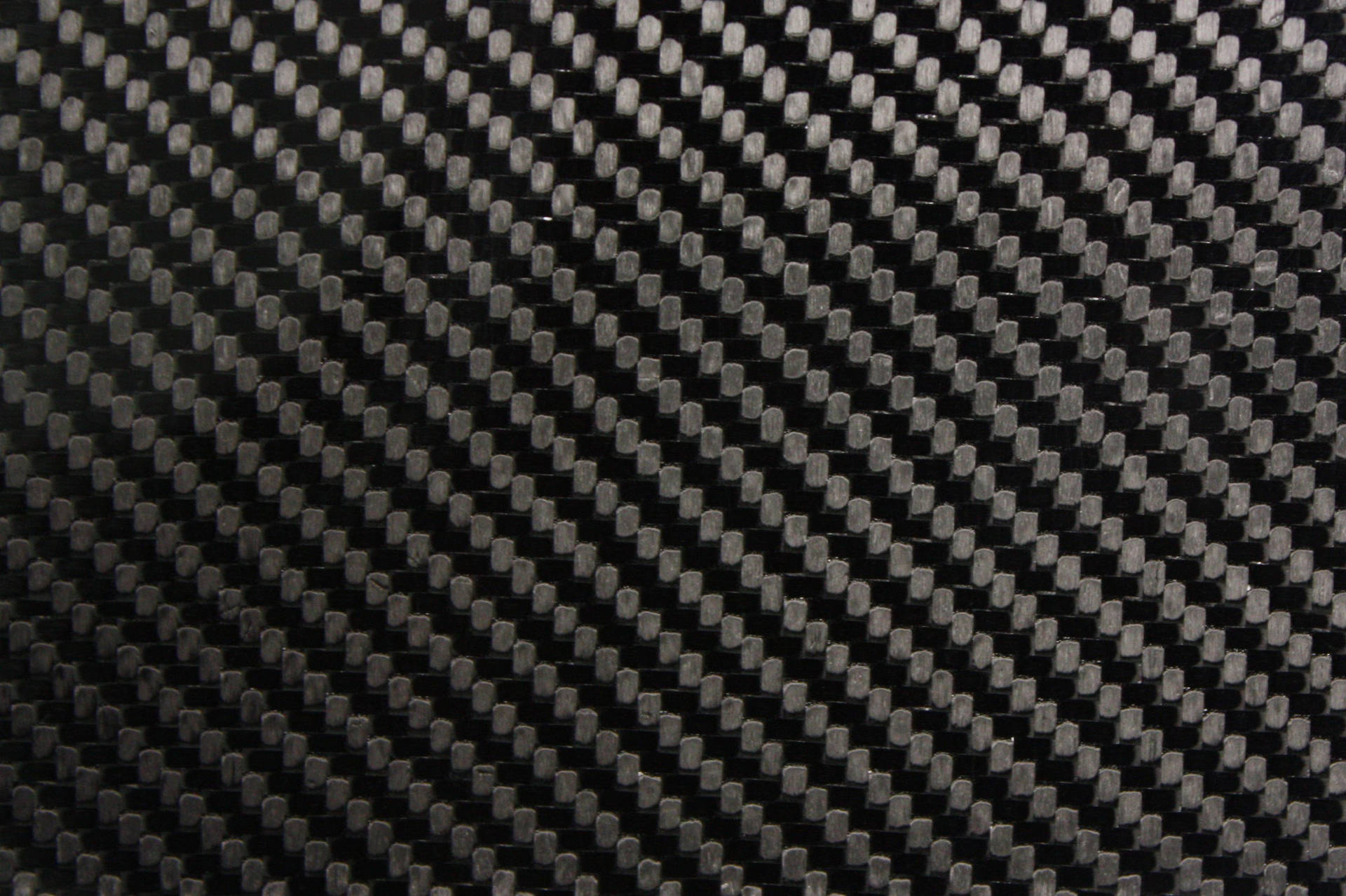 A close up of black and white carbon fiber fabric Wallpaper