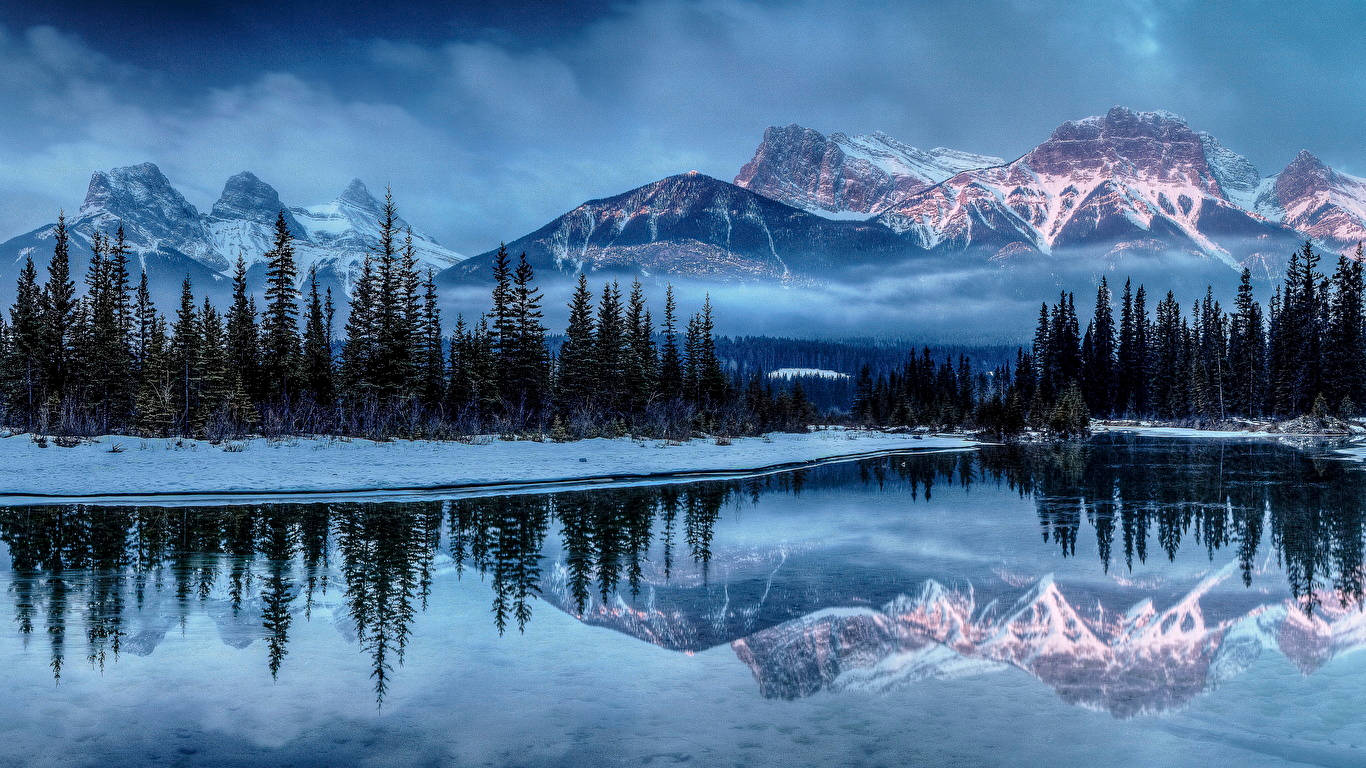 1366 X 768 Winter Lake By Forest And Mountain Wallpaper