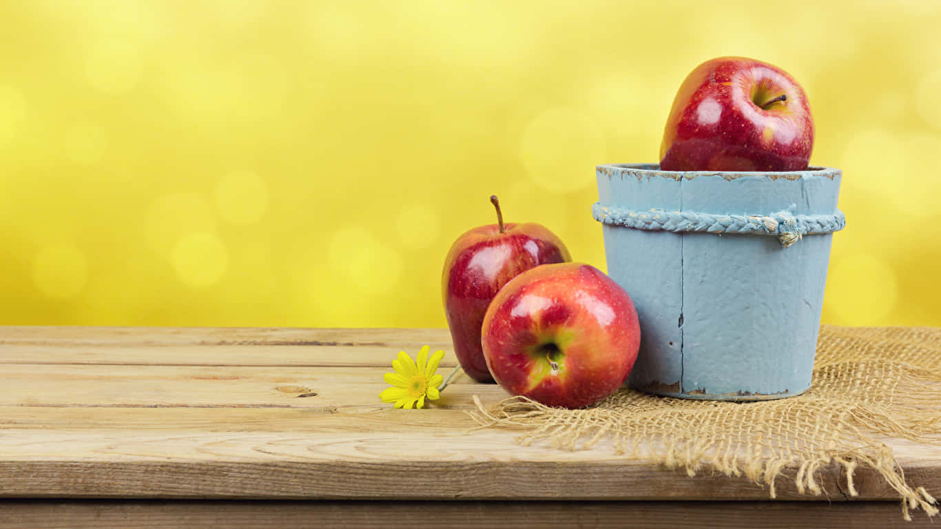 Red Apples In A Bucket On A Wooden Table
