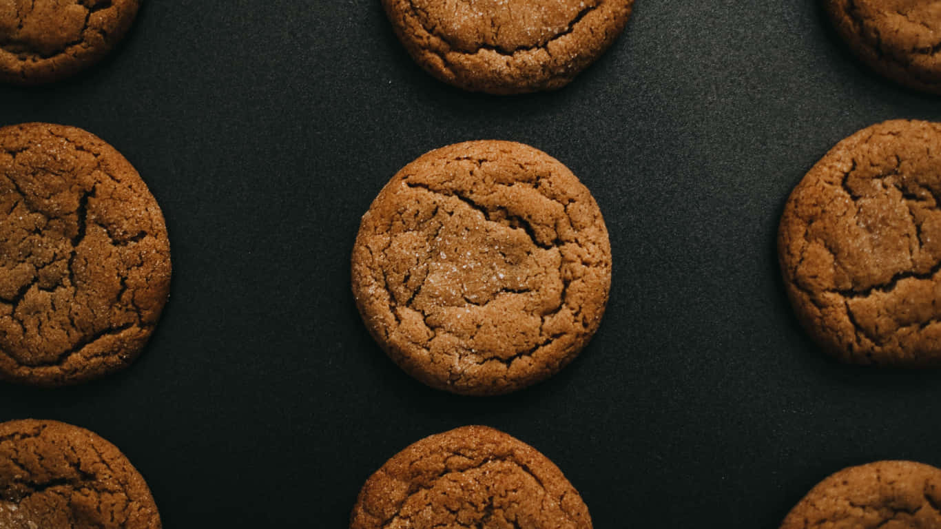 A Group Of Cookies On A Black Surface