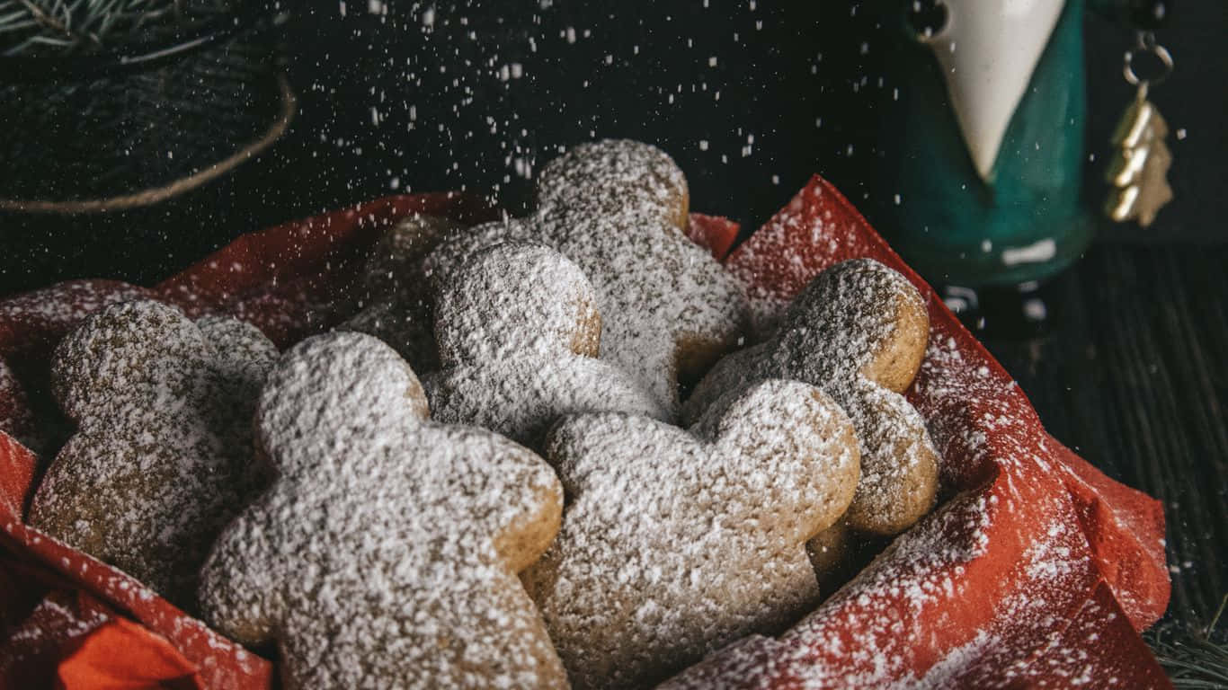 Gingerbread Cookies With Powdered Sugar On A Red Cloth