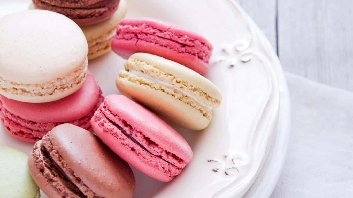 A Plate Of Macarons On A Wooden Table