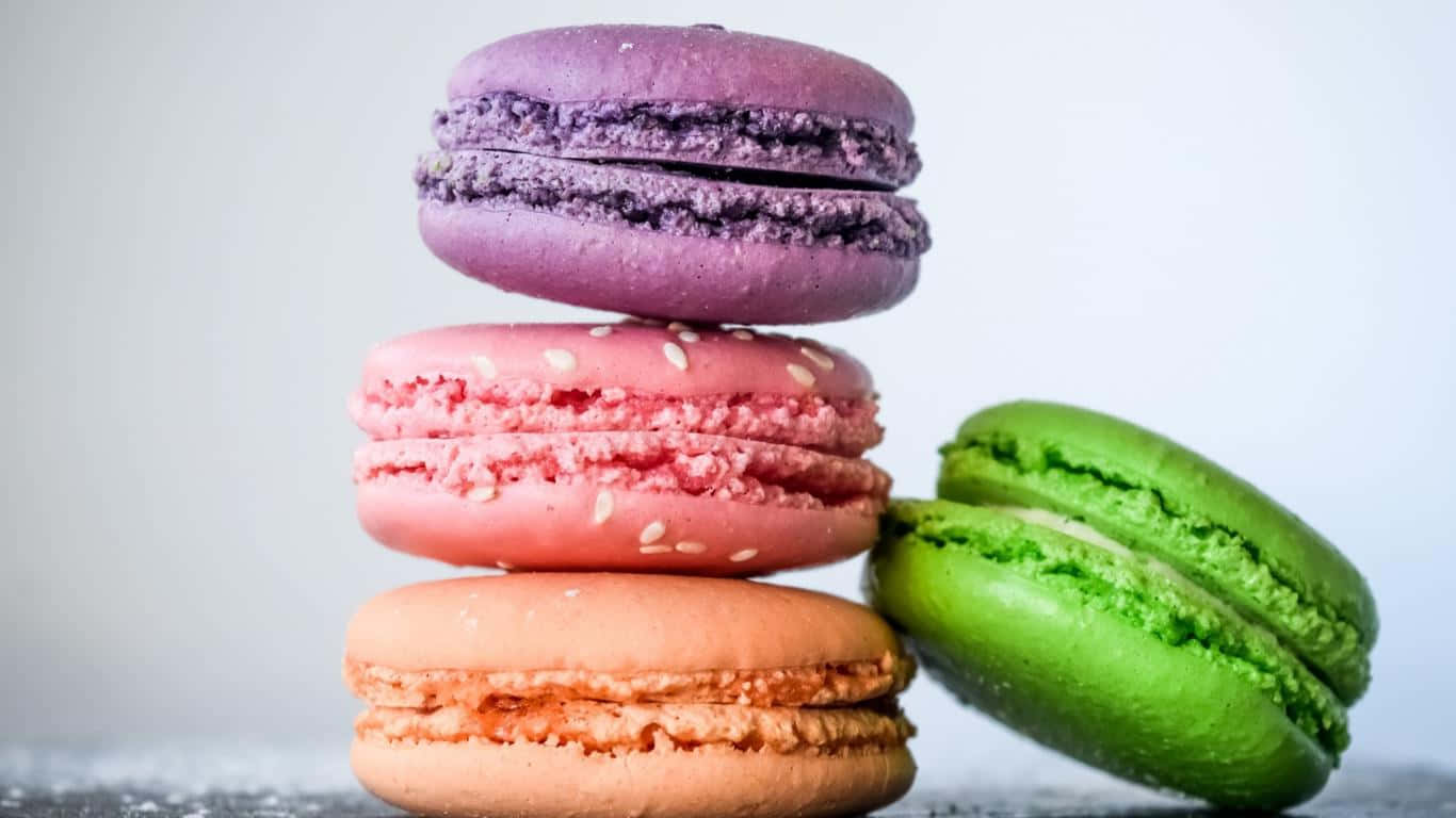 Three Colorful Macarons Stacked On Top Of Each Other