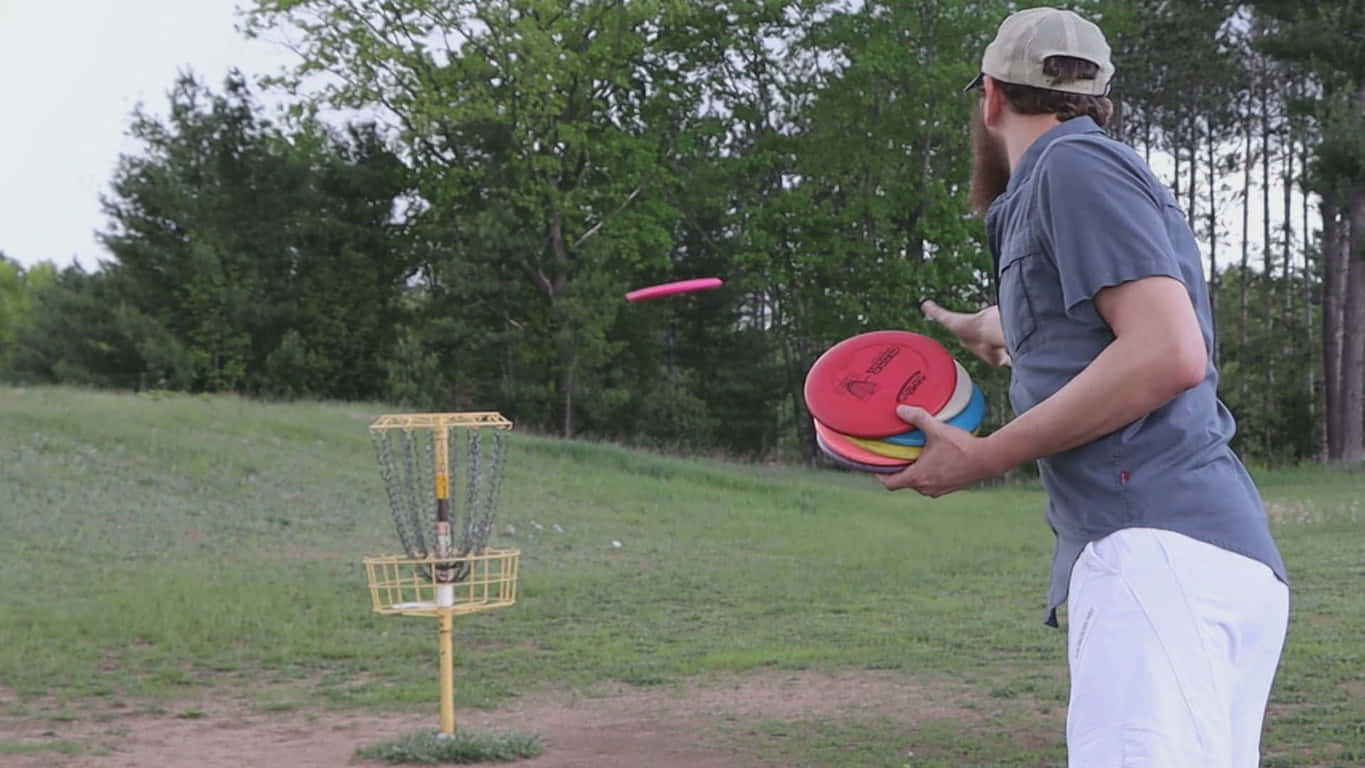 A Man Is Throwing A Frisbee In A Field