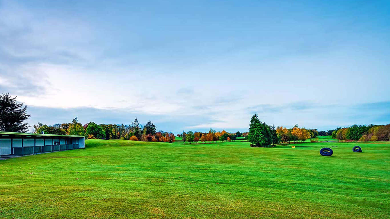Enjoy the Serene Golf Course with Lush Trees in the Background