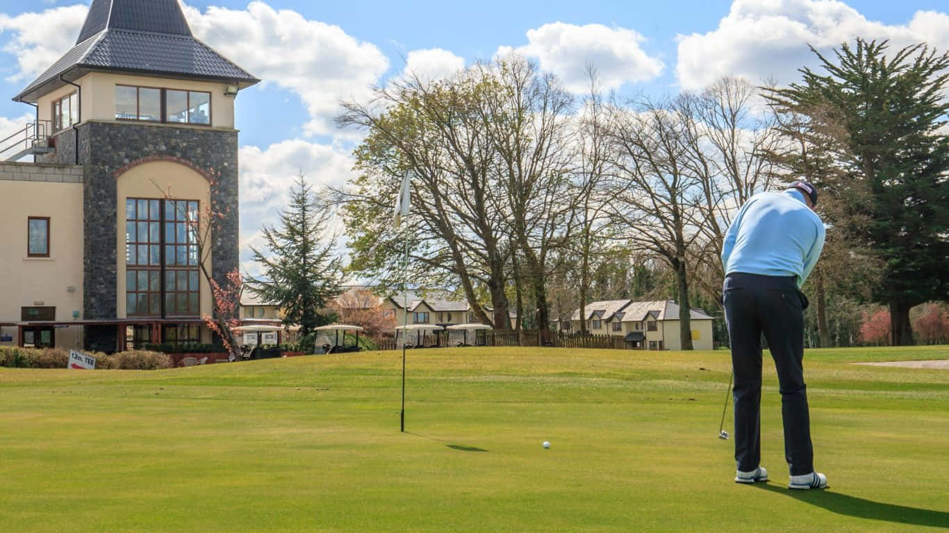 a man is playing golf in front of a church