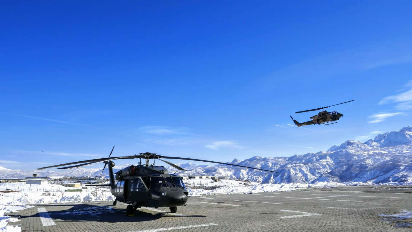 Aerial view of a fleet of Helicopters flying over the mountains