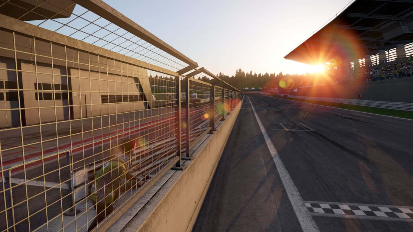 A Race Track With A Fence And Sun