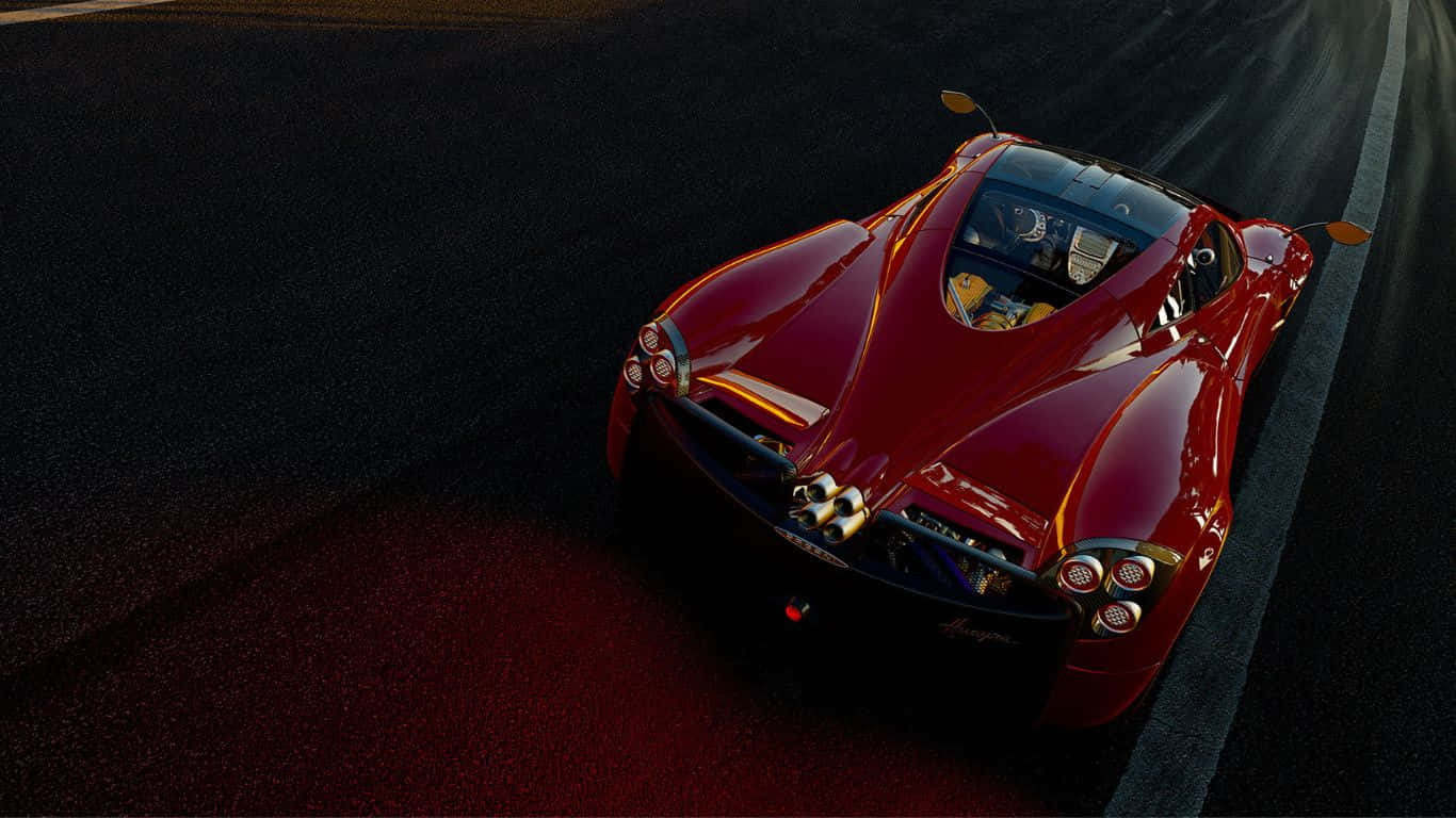 A Red Sports Car Driving Down A Track At Night