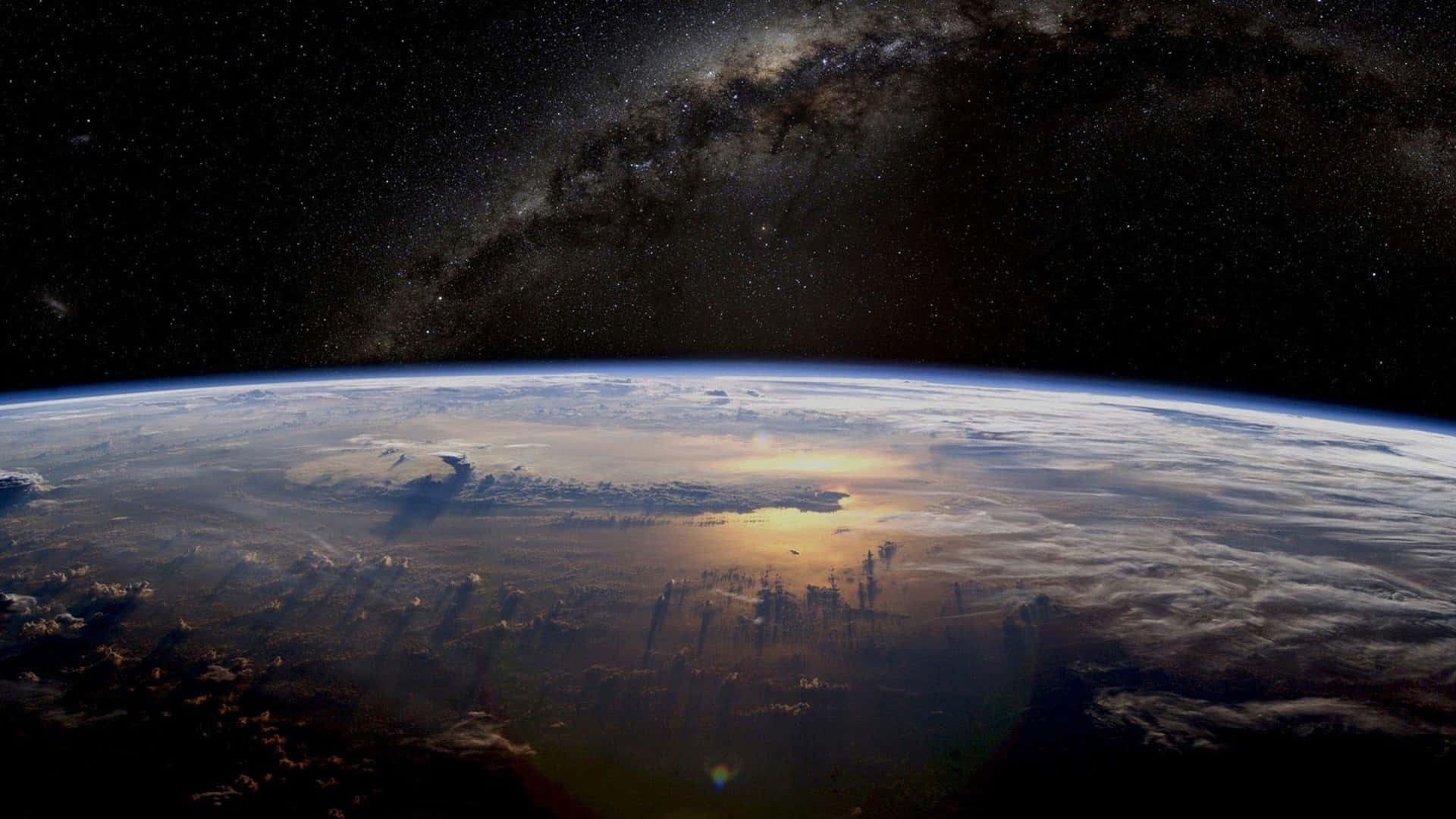 The Earth From Space With The Milky Way In The Background