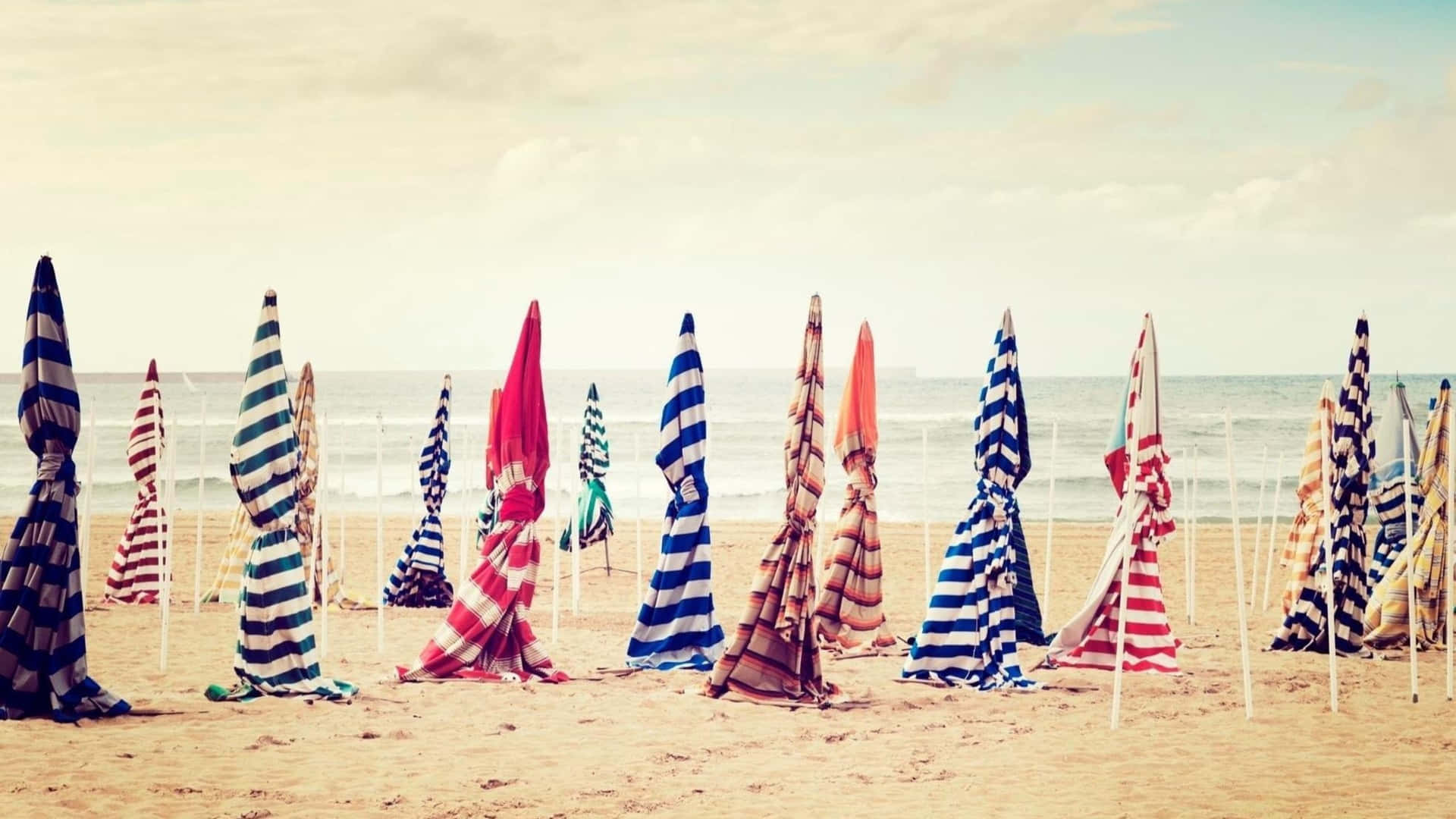 A Group Of Umbrellas On The Beach