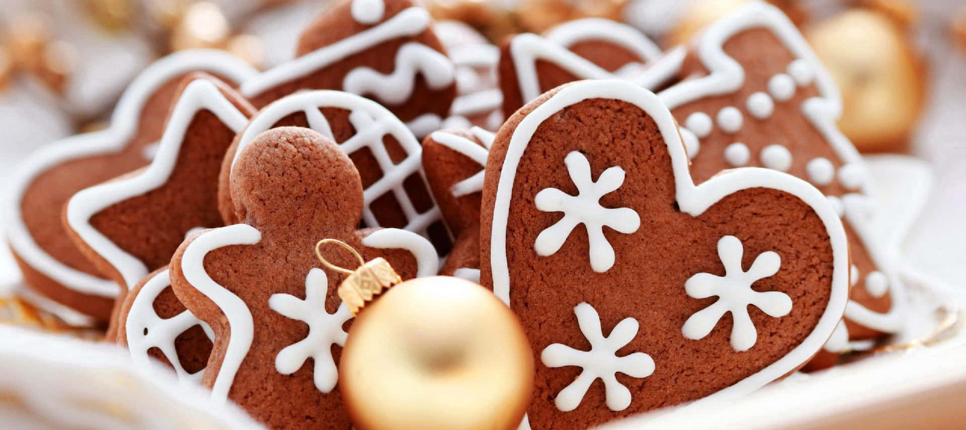Gingerbread Cookies With Gold Decorations On A Plate