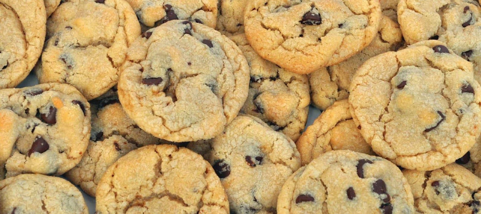 A Pile Of Chocolate Chip Cookies On A Plate