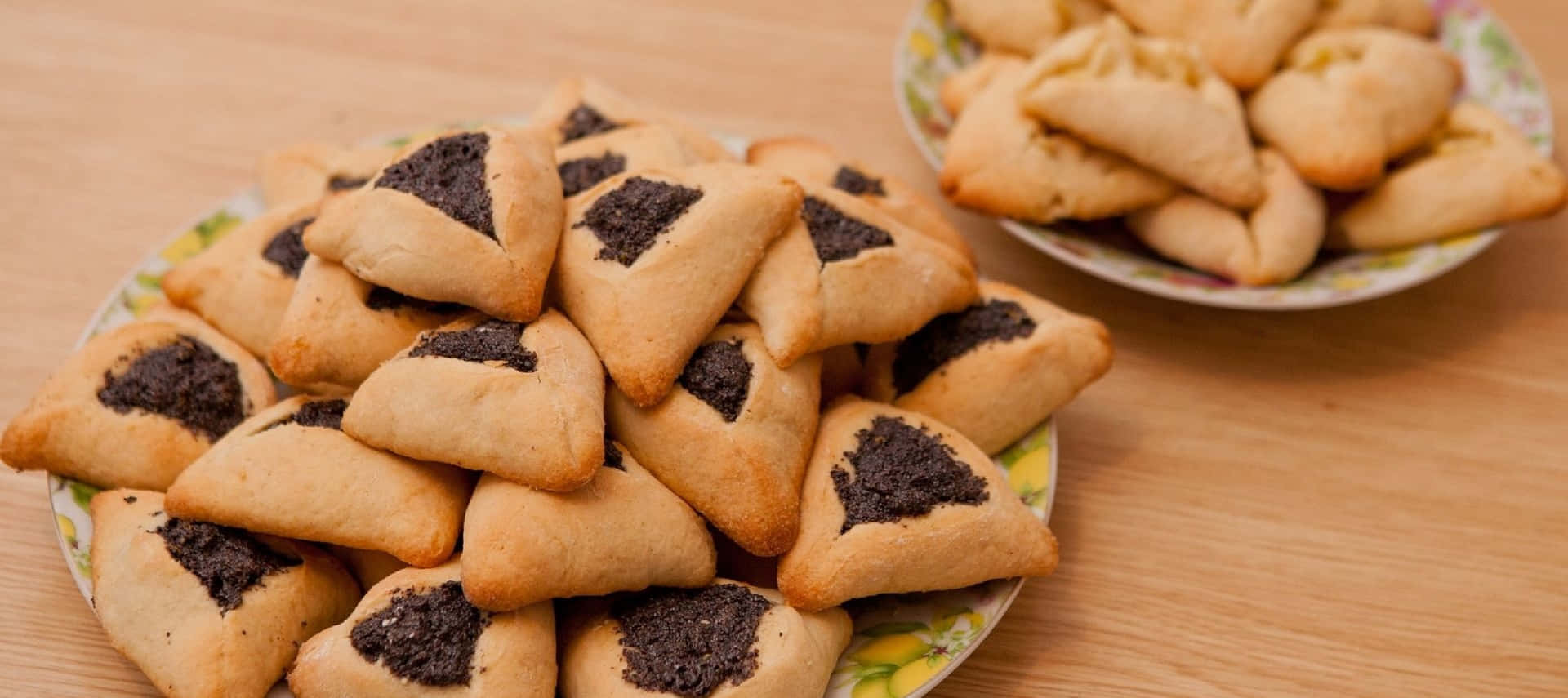 A Plate Of Hamantaschen With Black Filling
