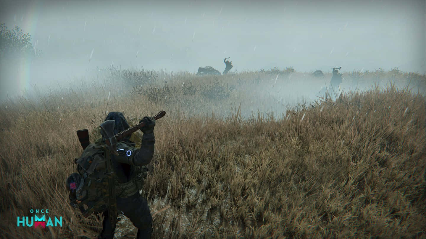 A Man Is Walking Through A Field With A Rifle