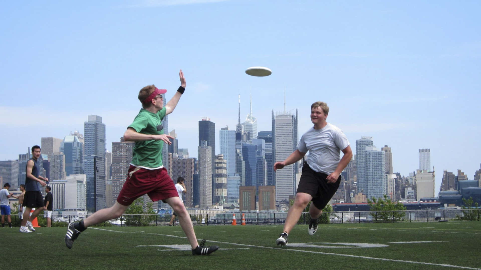 Ultimate Frisbee players tossing a frisbee in a laid-back competition.