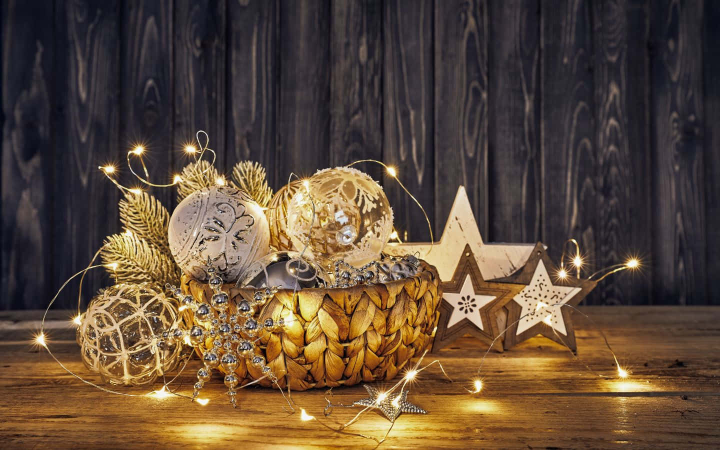 christmas decorations in a bowl on a wooden table Wallpaper