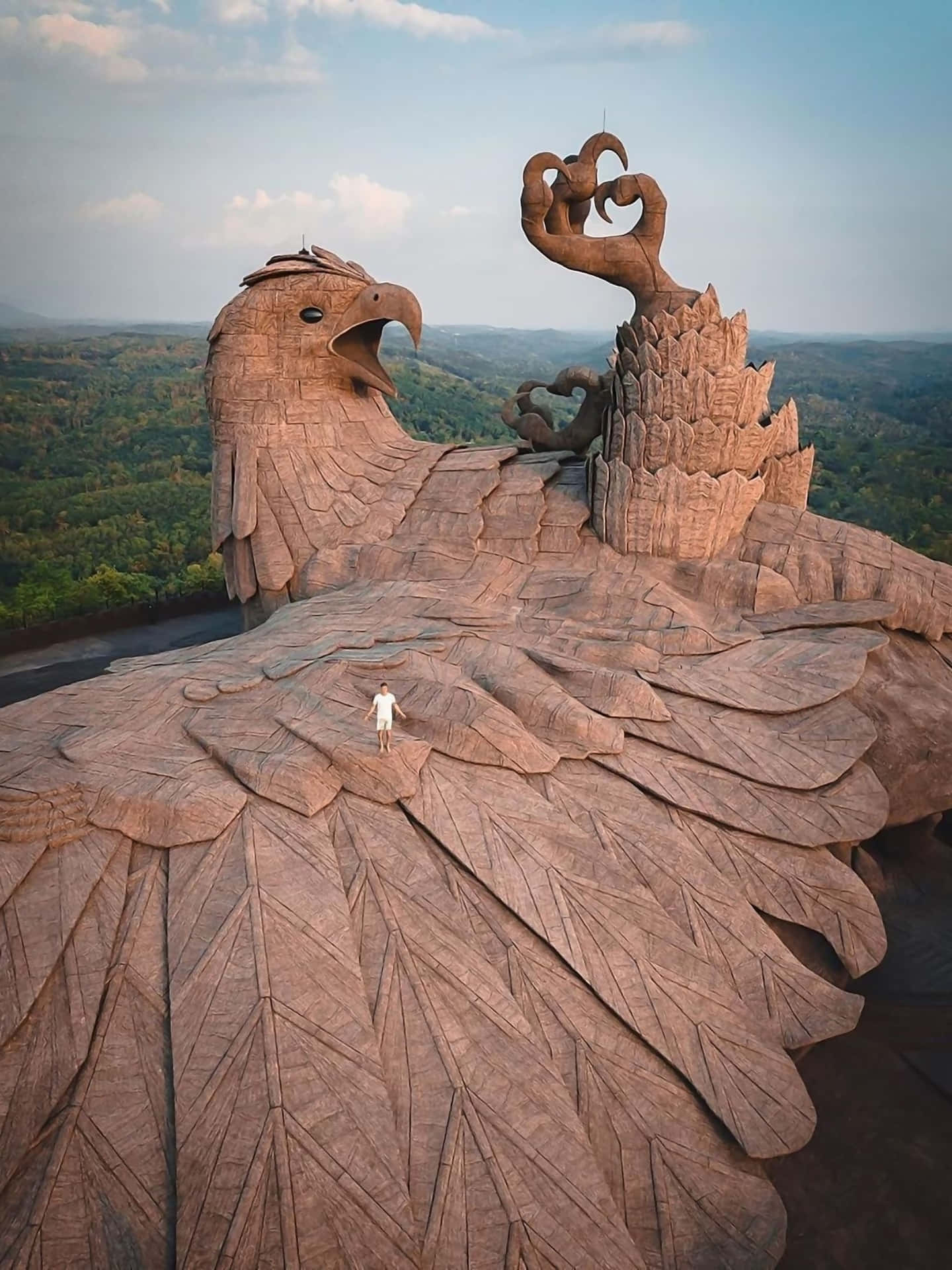 A Large Statue Of An Eagle On Top Of A Mountain Wallpaper