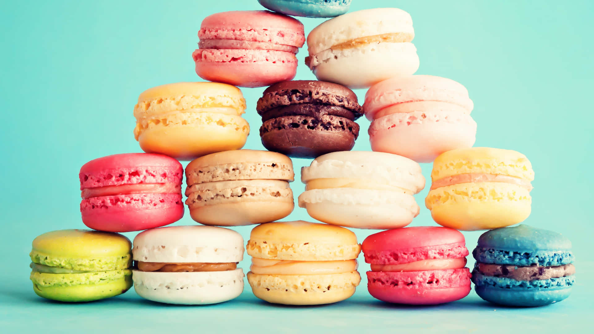 A Pyramid Of Macarons On A Blue Background