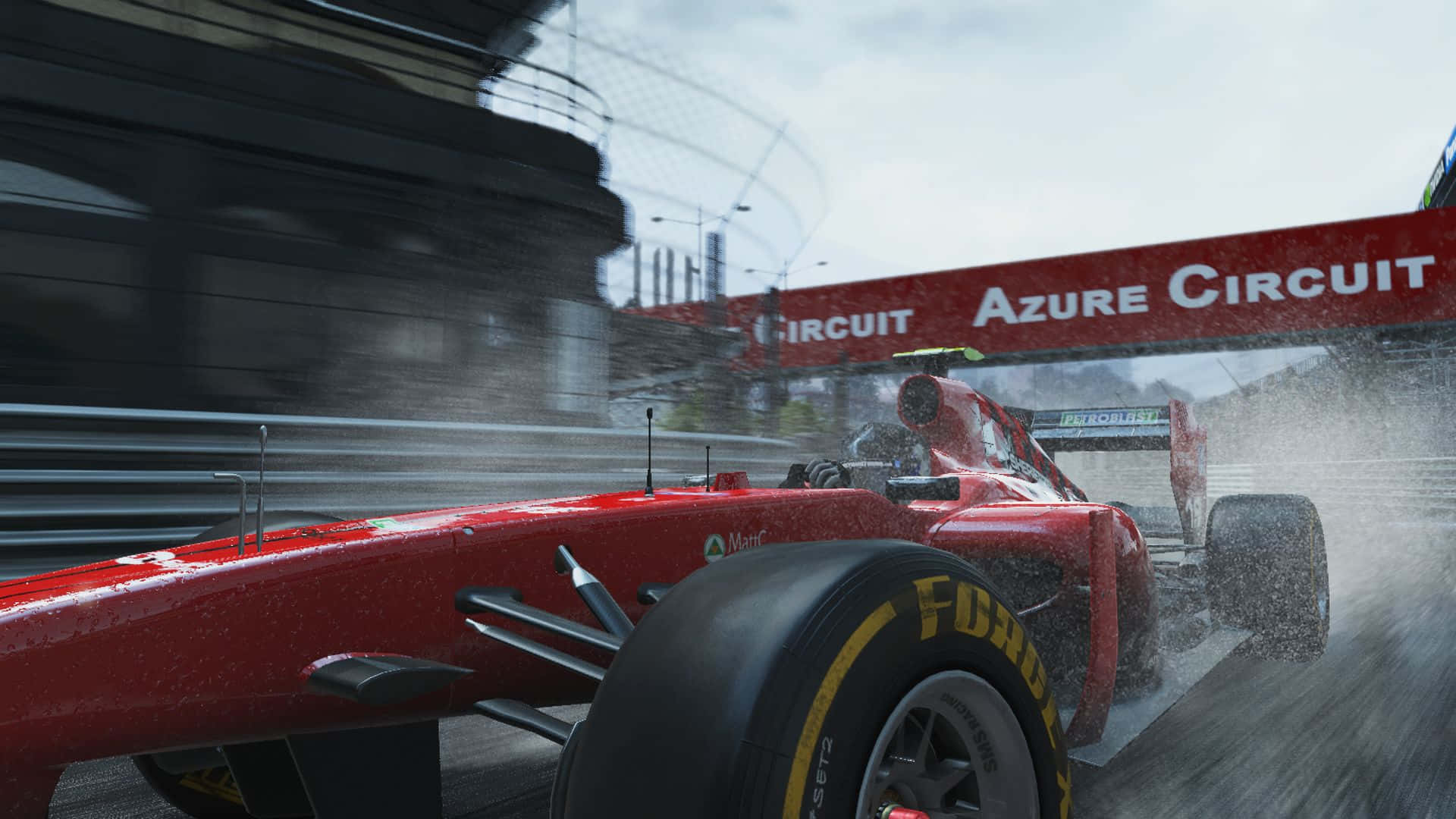 a red racing car driving through the rain