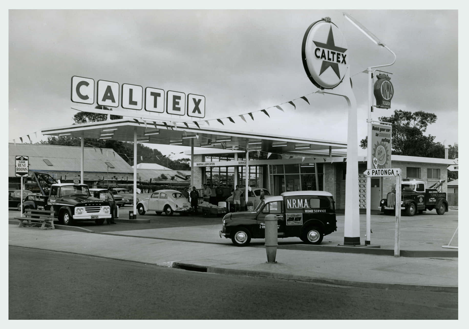 A Black And White Photo Of A Gas Station