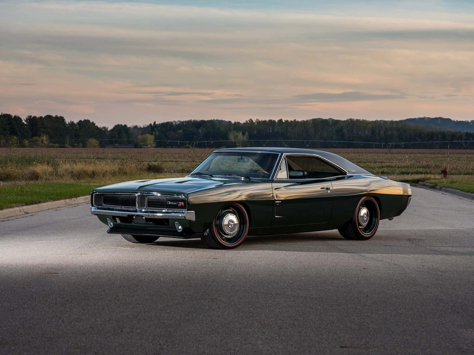 A Green Muscle Car Is Parked On The Road