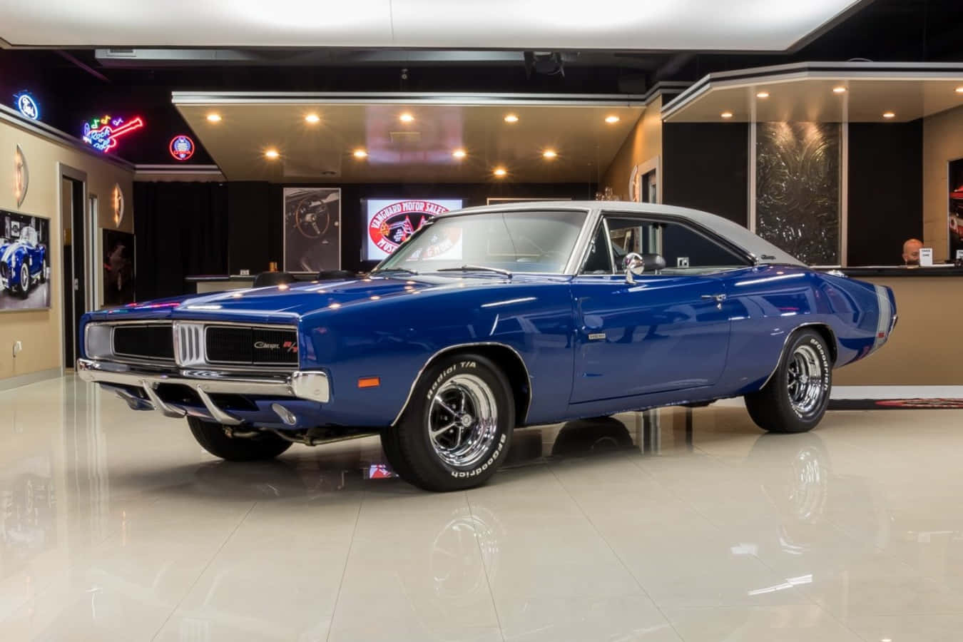 A Blue Dodge Charger Is Parked In A Garage