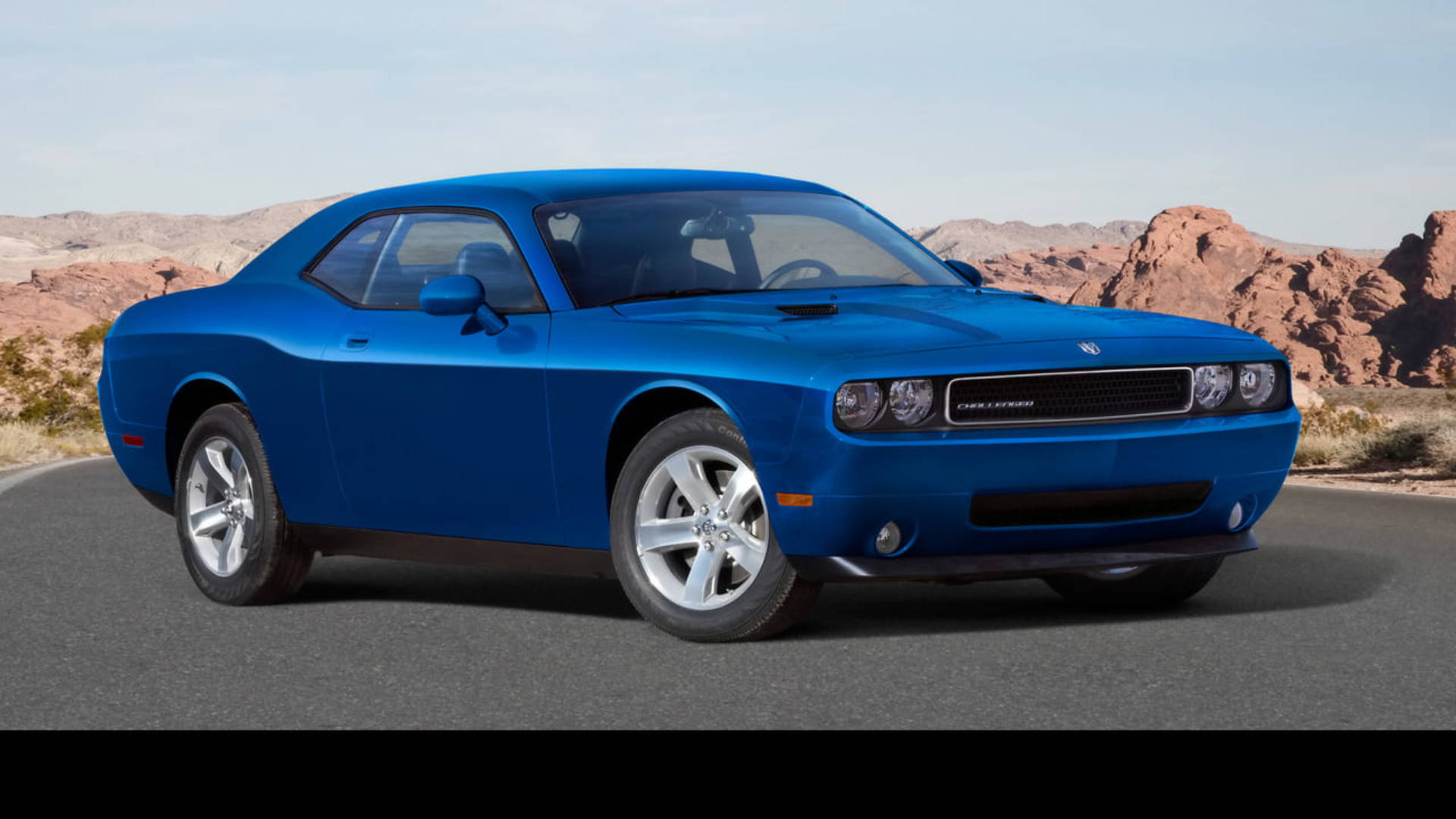 Powerful Blue Dodge Challenger in a Dynamic Pose Wallpaper