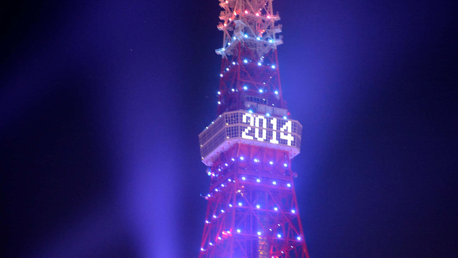 A breathtaking panoramic view of the iconic Blackpool Tower, illuminated against the night sky on New Year's Eve Wallpaper