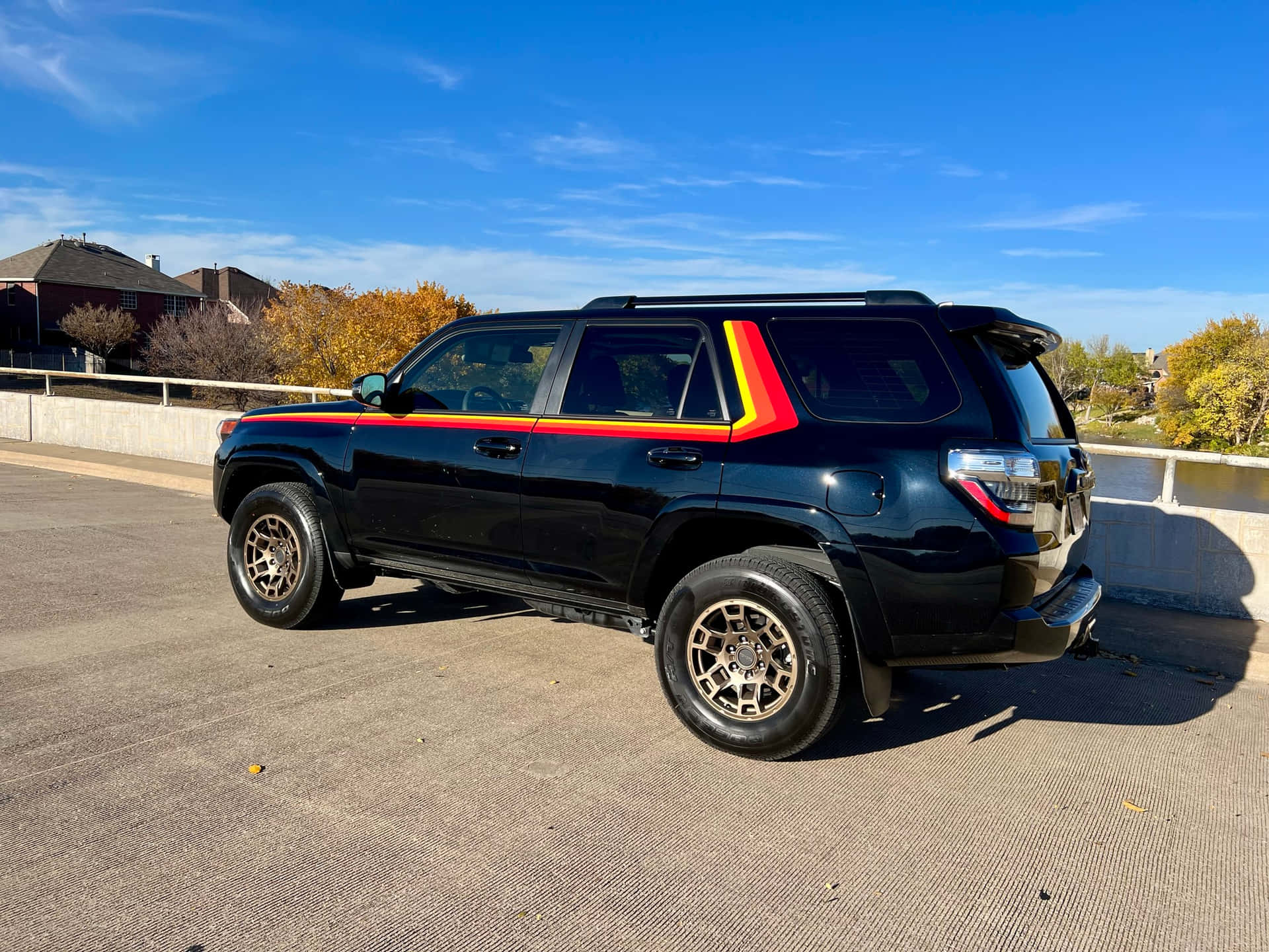 A Black Toyota 4runner With A Rainbow Stripe On The Side