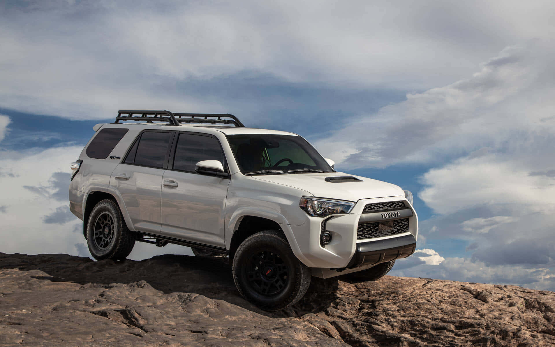 The White 2020 Toyota 4runner Is Parked On A Rocky Hill