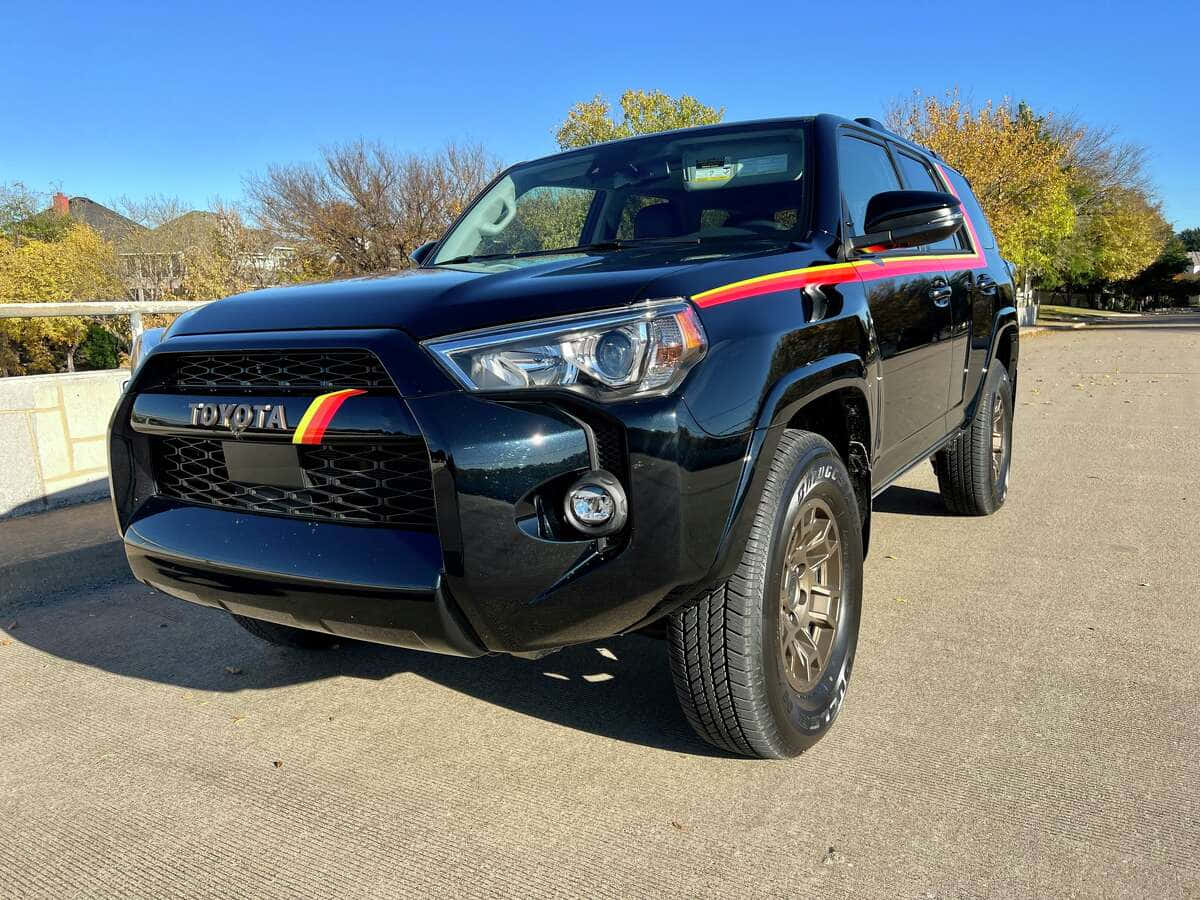 A Black Toyota 4runner With A Rainbow Stripe On The Side