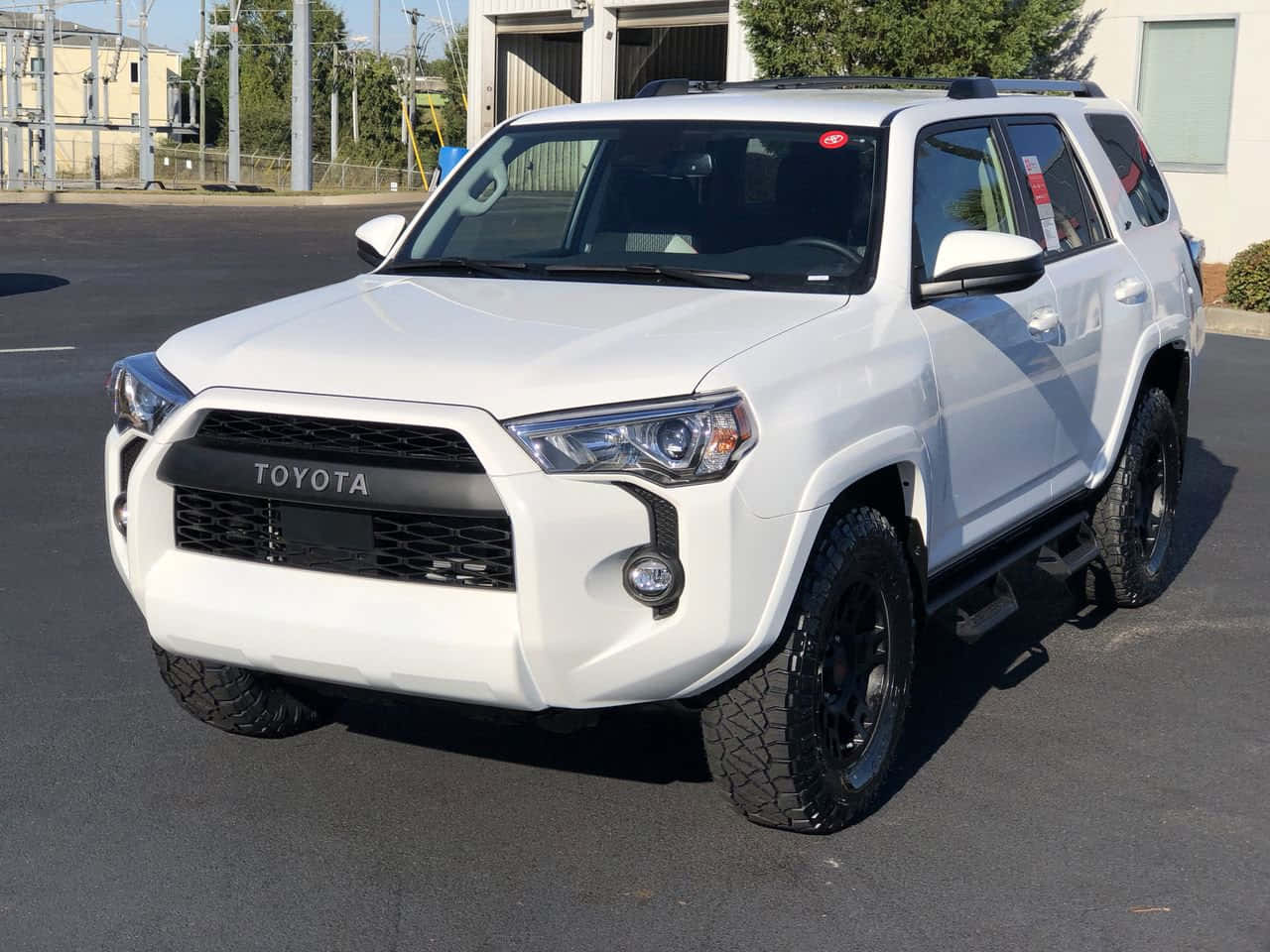 A White Toyota 4runner Is Parked In A Parking Lot