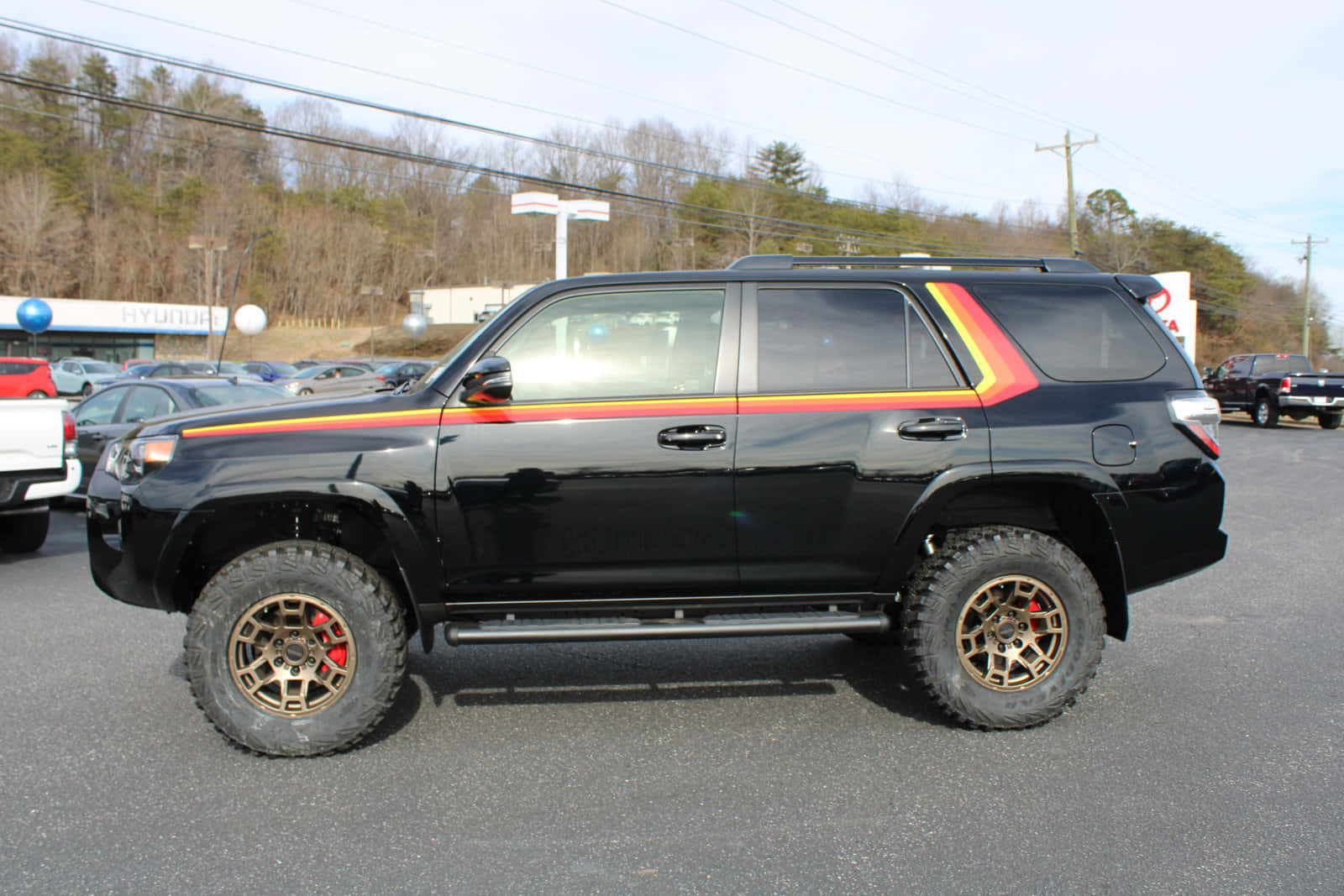 A Black Toyota 4runner With A Red Stripe