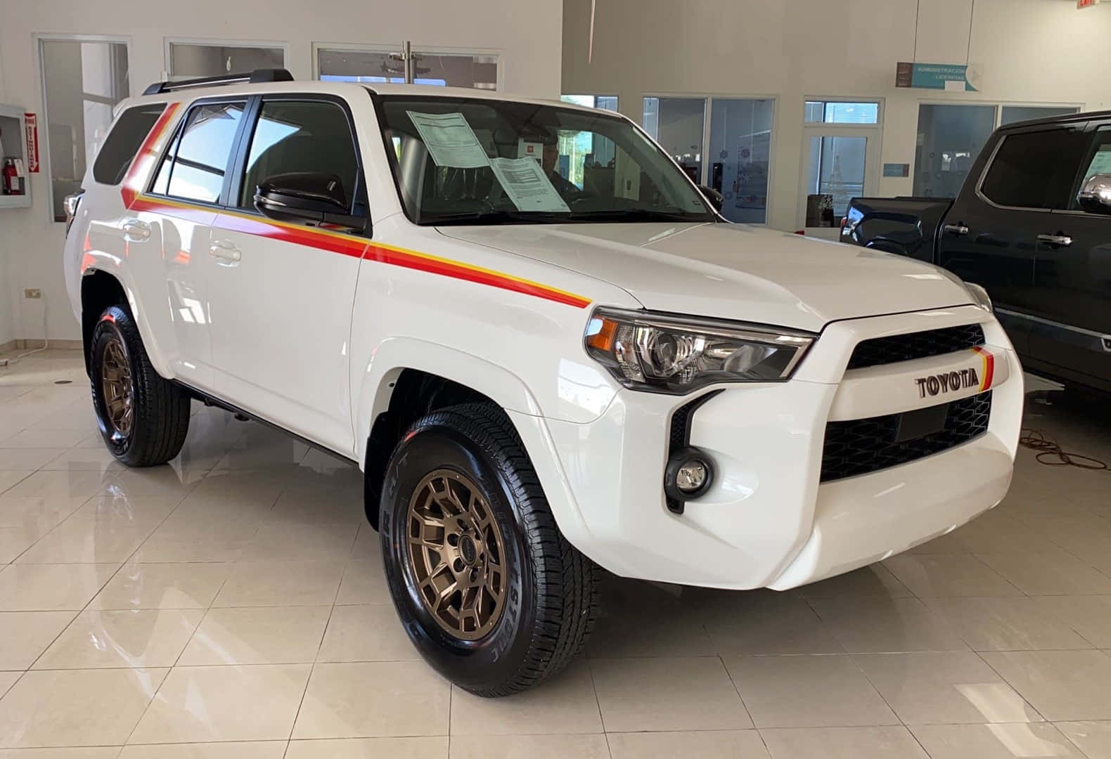 A White Toyota 4runner Is Parked In A Showroom
