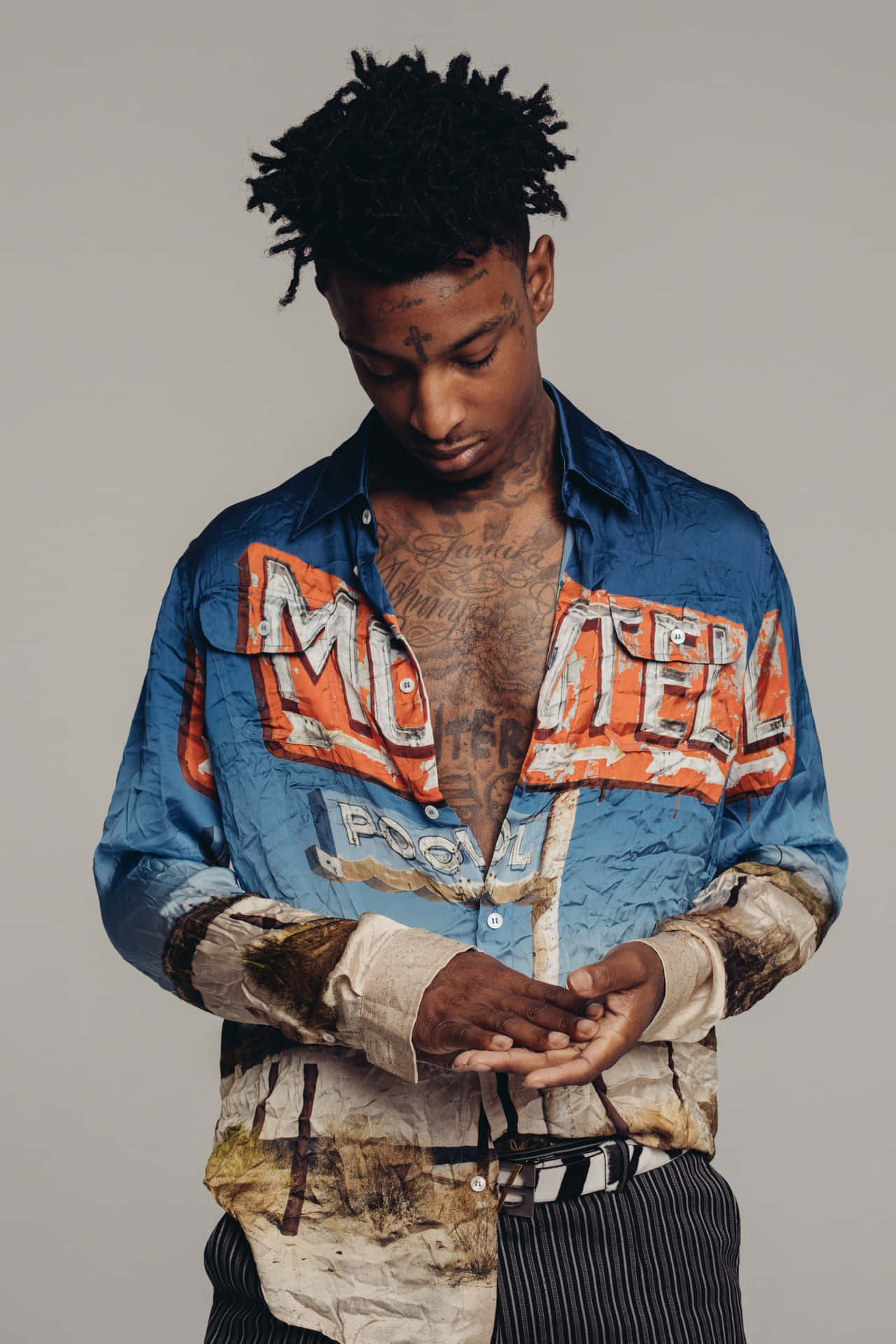 21 Savage poses in front of his signature XO brand logo.