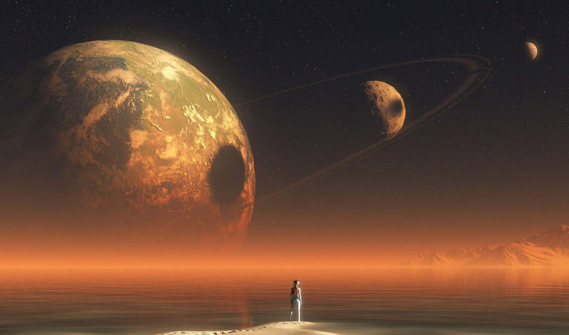 A Man Standing On A Beach Looking At The Planets