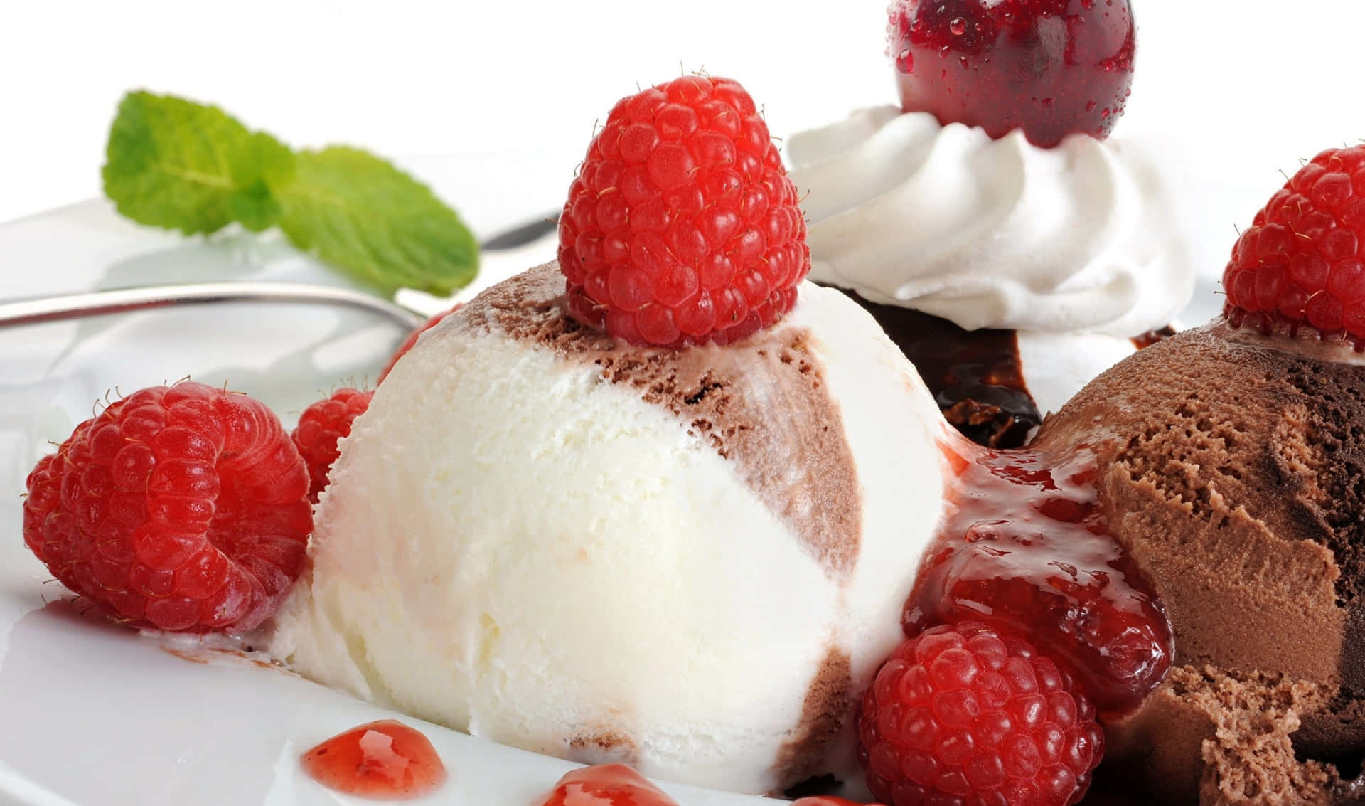 A White Plate With Ice Cream And Raspberries