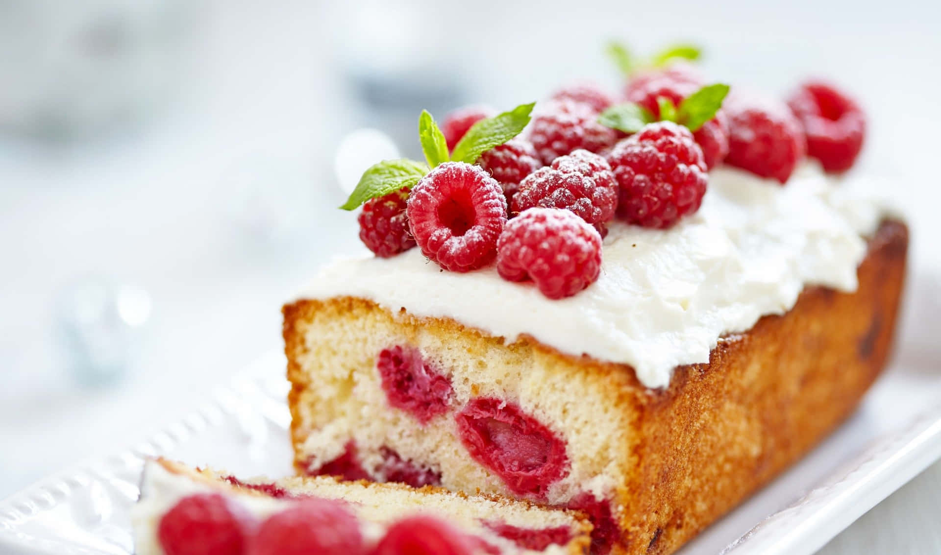 A Slice Of Raspberry Cake With Whipped Cream And Raspberries